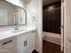 Bathroom with white vanity, black tile shower, and modern fixtures at 4030 N Palm Cir, Eloy, AZ 85131