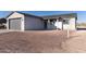 Front exterior showcasing the driveway, attached garage, and a partially landscaped yard at 4030 N Palm Cir, Eloy, AZ 85131