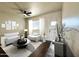 Inviting living room with white couch, dark wood-like floors, ceiling fan, and decorative accents at 4030 N Palm Cir, Eloy, AZ 85131