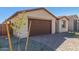 New home with a two-car garage and landscaping at 18741 E Elizar Dr, Gold Canyon, AZ 85118