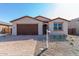One-story home with brown garage door and landscaped front yard at 18741 E Elizar Dr, Gold Canyon, AZ 85118