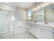 Modern bathroom with double vanity, white cabinets, and a soaking tub at 18741 E Elizar Dr, Gold Canyon, AZ 85118