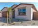 Newly built house with light-colored exterior and a well-maintained front yard at 18741 E Elizar Dr, Gold Canyon, AZ 85118