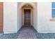 Front entry with a brick walkway and brown door at 18741 E Elizar Dr, Gold Canyon, AZ 85118