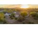 Aerial view of a single-story house with desert landscaping and mountain views at sunset at 39012 N 8Th St, Phoenix, AZ 85086