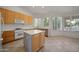 Eat-in kitchen with wood cabinets, island, and ample natural light at 39012 N 8Th St, Phoenix, AZ 85086