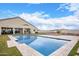 Inviting backyard pool with expansive patio and grassy area at 13621 W Tuckey Ct, Glendale, AZ 85307