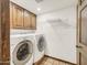 Laundry room with washer, dryer, and overhead shelving at 2237 E Captain Dreyfus Ave, Phoenix, AZ 85022