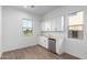 Small kitchenette with white cabinets, sink, and mini-fridge at 16455 W Avenida Del Sol --, Surprise, AZ 85387