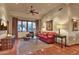 Bright sitting room with a comfortable sofa and large windows, offering views of the backyard at 11440 E Black Rock Rd, Scottsdale, AZ 85255