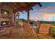 Relaxing patio with fireplace, seating area, and stunning mountain views at 11440 E Black Rock Rd, Scottsdale, AZ 85255