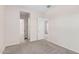 Bright bedroom with neutral carpeting and an ensuite bathroom at 24041 N 171St Ln, Surprise, AZ 85387