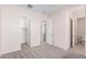 Bedroom with neutral carpeting and access to bathroom and closet at 24041 N 171St Ln, Surprise, AZ 85387