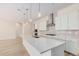 Modern kitchen with white cabinets, quartz countertops, and stainless steel appliances at 24041 N 171St Ln, Surprise, AZ 85387