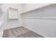 Large walk-in closet with double hanging rods and neutral carpeting at 24041 N 171St Ln, Surprise, AZ 85387