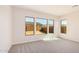 Bedroom with neutral carpeting and three large windows at 24041 N 171St Ln, Surprise, AZ 85387