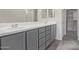 Double vanity bathroom with gray cabinets and a large mirror at 5530 S 111Th St, Mesa, AZ 85212