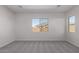 Bright bedroom with grey carpet and a window at 24030 N 171St Dr, Surprise, AZ 85387
