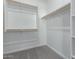 Spacious walk-in closet, built-in shelves, and hanging rods at 24030 N 171St Dr, Surprise, AZ 85387