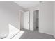 Bright bedroom with grey carpet and access to closet at 24030 N 171St Dr, Surprise, AZ 85387