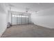 Spacious garage with open floor plan and overhead door at 24030 N 171St Dr, Surprise, AZ 85387