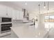 Modern kitchen with white cabinets, stainless steel appliances, and a large island at 24030 N 171St Dr, Surprise, AZ 85387