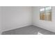 Simple bedroom with grey carpet and a window at 24030 N 171St Dr, Surprise, AZ 85387