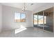 Bright dining room with sliding glass doors and chandelier at 24030 N 171St Dr, Surprise, AZ 85387