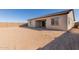 Large backyard with sand-colored ground and a covered patio at 24030 N 171St Dr, Surprise, AZ 85387