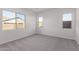 Spacious bedroom with grey carpet and multiple windows at 24030 N 171St Dr, Surprise, AZ 85387