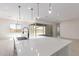 Modern kitchen island with white quartz countertops and black faucet at 24030 N 171St Dr, Surprise, AZ 85387