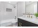 Updated bathroom with white subway tile, new vanity, and bathtub at 2033 W Sunnyside Ave, Phoenix, AZ 85029