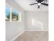 Bright bedroom with wood-look floors, large window, and ceiling fan at 2033 W Sunnyside Ave, Phoenix, AZ 85029