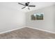 Spacious bedroom featuring wood-look floors and a ceiling fan at 2033 W Sunnyside Ave, Phoenix, AZ 85029