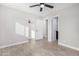Well-lit bedroom with wood-look floors, closet, and adjacent bathroom at 2033 W Sunnyside Ave, Phoenix, AZ 85029