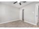 Simple bedroom with wood-look floors, ceiling fan, and closet at 2033 W Sunnyside Ave, Phoenix, AZ 85029