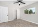 Spacious bedroom with wood-look floors, sliding closet doors, and a window at 2033 W Sunnyside Ave, Phoenix, AZ 85029