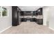 Modern kitchen with dark cabinetry, stainless steel appliances, and quartz countertops at 2033 W Sunnyside Ave, Phoenix, AZ 85029