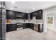 Modern kitchen with dark cabinetry, stainless steel appliances, and quartz countertops at 2033 W Sunnyside Ave, Phoenix, AZ 85029