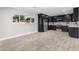 Modern kitchen with dark cabinetry, stainless steel appliances, and quartz countertops at 2033 W Sunnyside Ave, Phoenix, AZ 85029