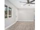 Bright and airy living room with wood-look tile flooring and ceiling fan at 2033 W Sunnyside Ave, Phoenix, AZ 85029