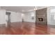 Living room with hardwood floors and a stone fireplace at 13451 N 93Rd Way, Scottsdale, AZ 85260