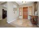 Bright and spacious entryway with tile floors and wooden console table at 22838 N De La Guerra Dr, Sun City West, AZ 85375