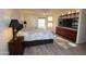 Main bedroom with built-in shelving and large TV at 4601 E Desert Cove Ave, Phoenix, AZ 85028