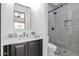 Modern bathroom with dark vanity and walk-in shower at 11475 E Paradise Ln, Scottsdale, AZ 85255