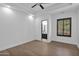 Light and airy bedroom with hardwood floors and access to bathroom at 11475 E Paradise Ln, Scottsdale, AZ 85255