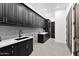 Spacious laundry room with ample cabinetry and counter space at 11475 E Paradise Ln, Scottsdale, AZ 85255