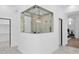 Spa-like shower with glass enclosure and marble tile at 11475 E Paradise Ln, Scottsdale, AZ 85255