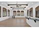 Large game room with hardwood floors, wet bar, and plenty of natural light at 11475 E Paradise Ln, Scottsdale, AZ 85255