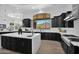 Gourmet kitchen boasts modern cabinetry, large island, and mountain views at 11475 E Paradise Ln, Scottsdale, AZ 85255